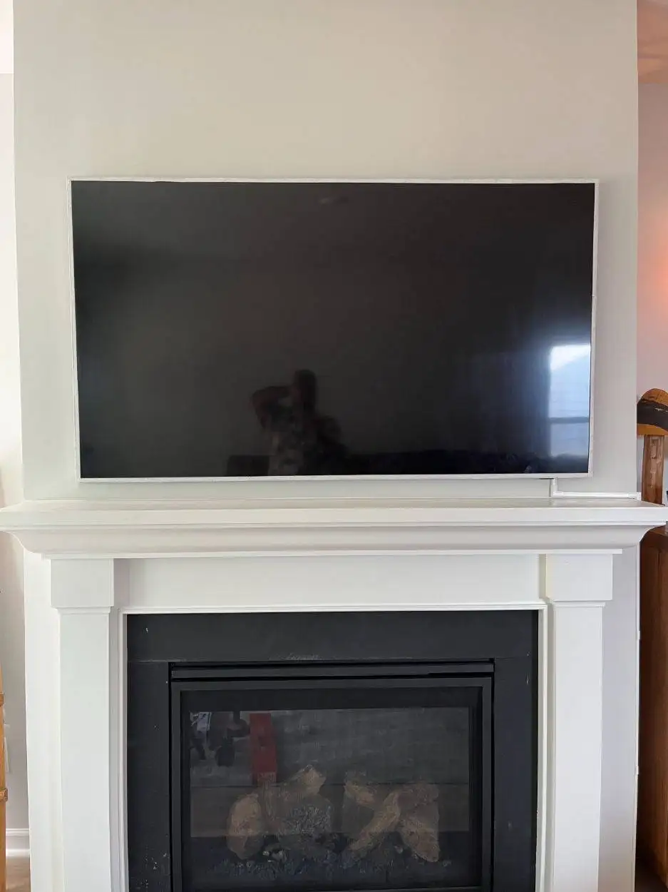 Wall-mounted TV positioned above the fireplace